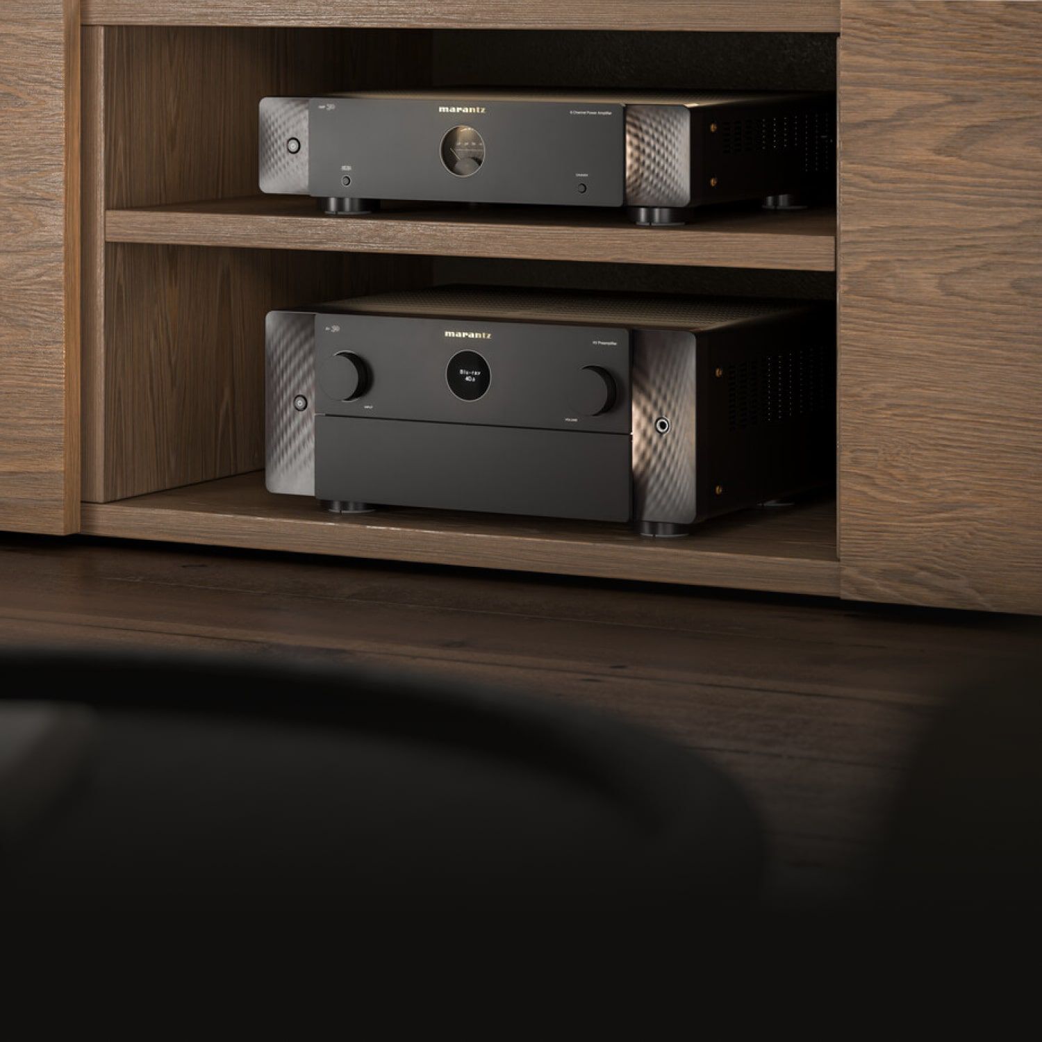 Black AV30 sitting inside dark wood media console