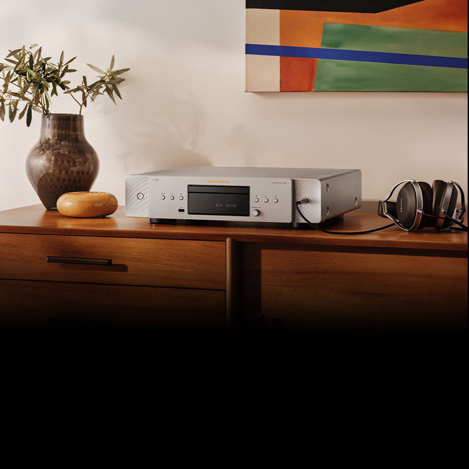 CD 70 Silver-Gold sitting on a dresser with a plant