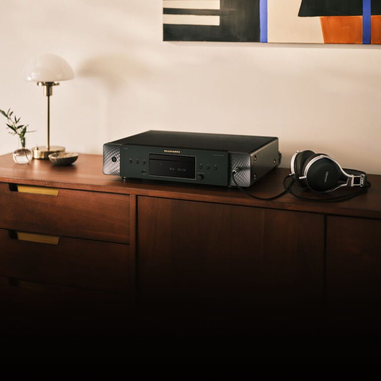 CD 70 Black sitting on a dresser with a lamp