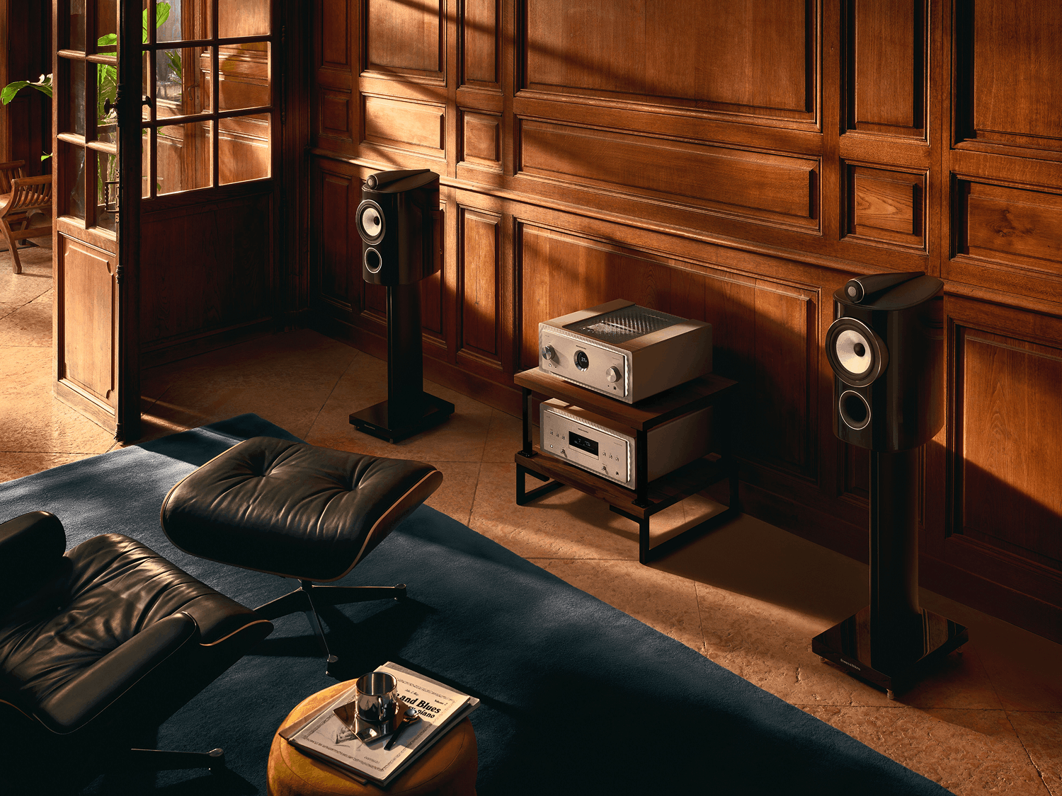 Loudspeakers with Marantz products in between on a shelf