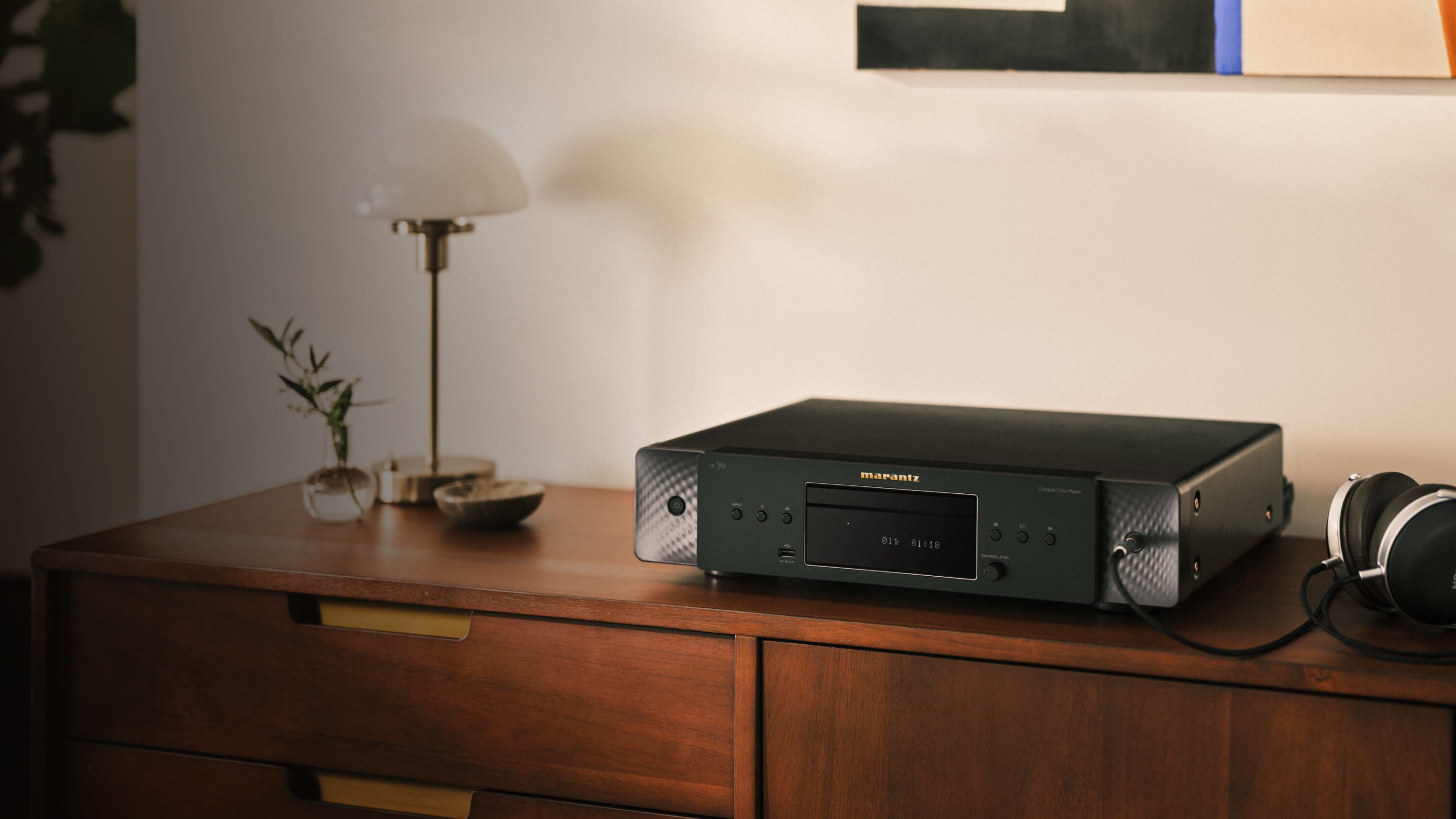 CD 70 Black sitting on a dresser with a lamp
