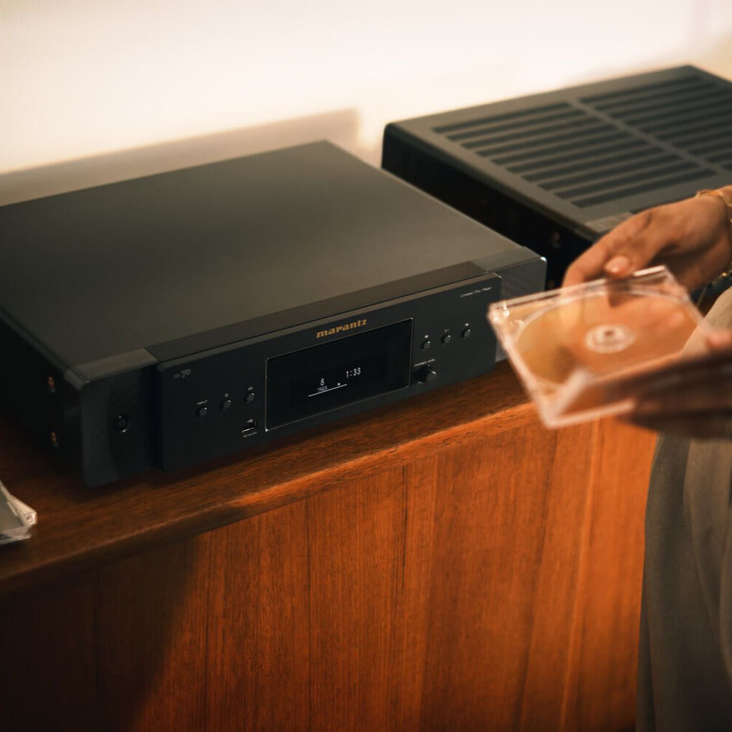 CD 70 Black sitting on a dresser with a lamp